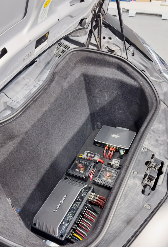 Car audio amplifier installation with professional wiring in a car