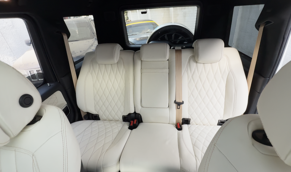 Premium car seat upholstery Dubai featuring custom white diamond-stitched leather seats installed by Carmods Dubai.