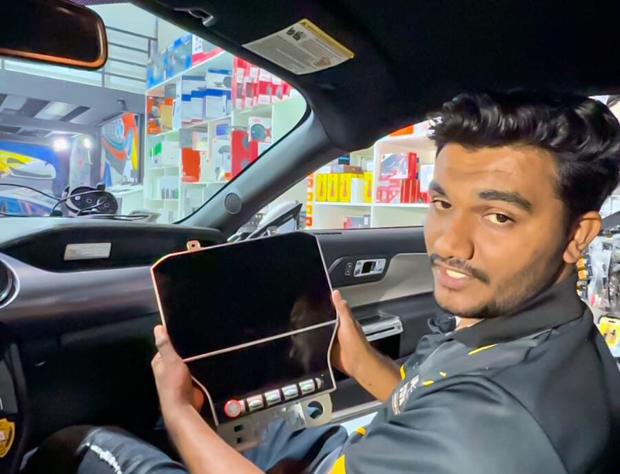 Technician showing an Android screen before professional installation in a car in Dubai.